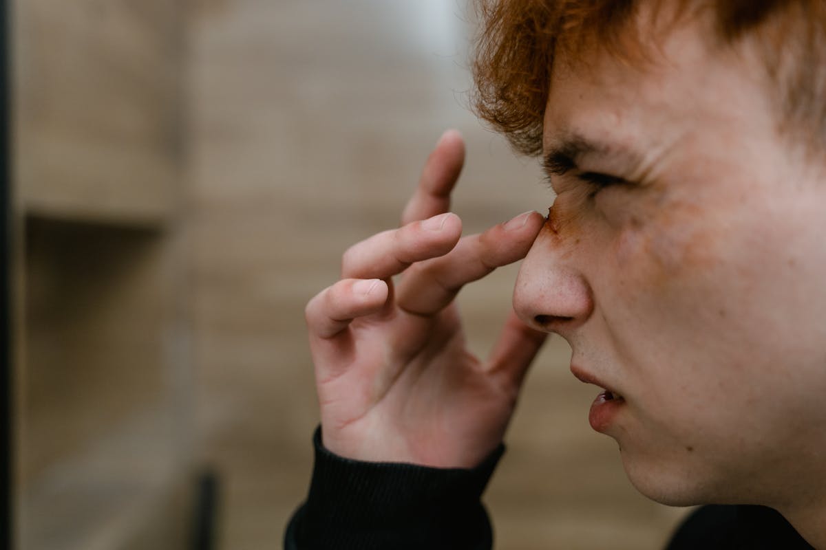 A Man Touching the Wound on His Nose