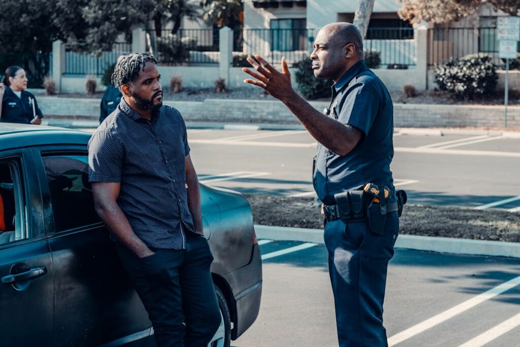 Bearded Man Leaning on the Car Looking at the Policeman