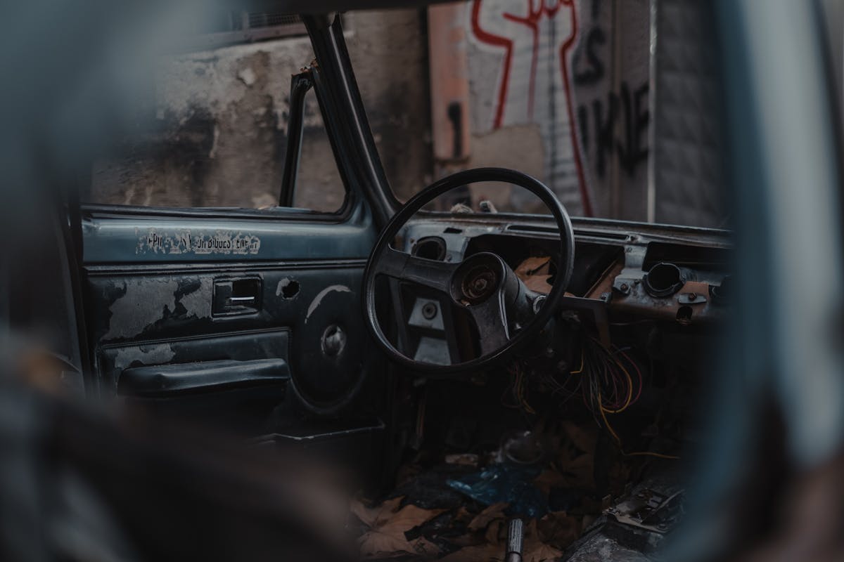 Through broken window of aged car