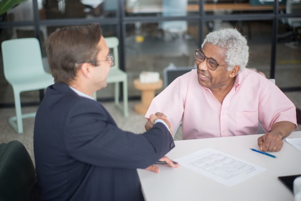Men Sitting Inside the Office while Doing Handshake